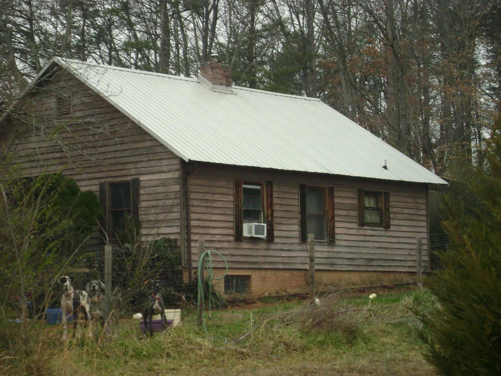 White metal roof on an old wood sided farmhouse, from a Metal Roof Installation job in Lake Lillian